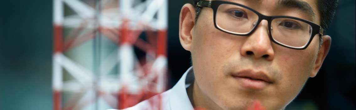 Close-up of man with industrial model